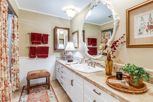 bathroom featuring vanity, tile patterned floors, and ornamental molding