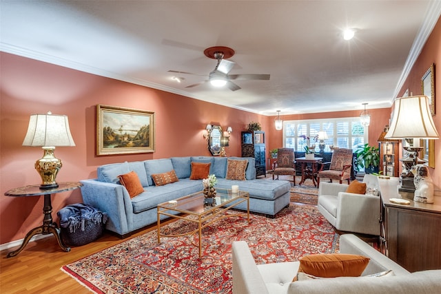 living room featuring ceiling fan, wood-type flooring, and ornamental molding