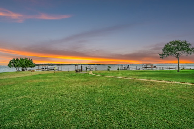 view of home's community featuring a water view and a yard