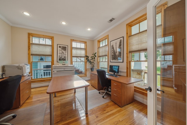 office with plenty of natural light, crown molding, and light hardwood / wood-style flooring