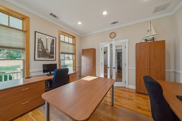 office space with french doors, ornamental molding, and light hardwood / wood-style flooring