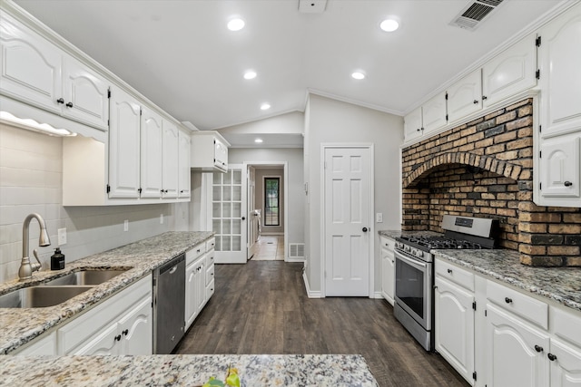 kitchen with white cabinets, sink, lofted ceiling, and stainless steel appliances