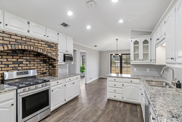 kitchen with crown molding, stainless steel appliances, dark hardwood / wood-style flooring, hanging light fixtures, and white cabinets