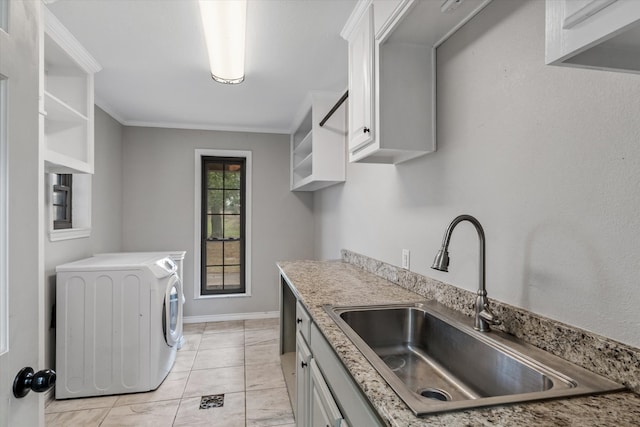 kitchen with white cabinetry, washer / clothes dryer, ornamental molding, and sink