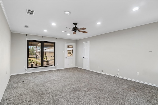 spare room with ornamental molding, carpet floors, and ceiling fan