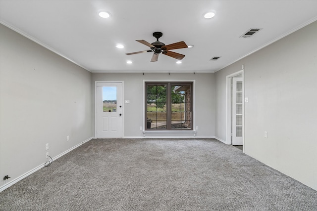 carpeted spare room featuring ceiling fan and crown molding