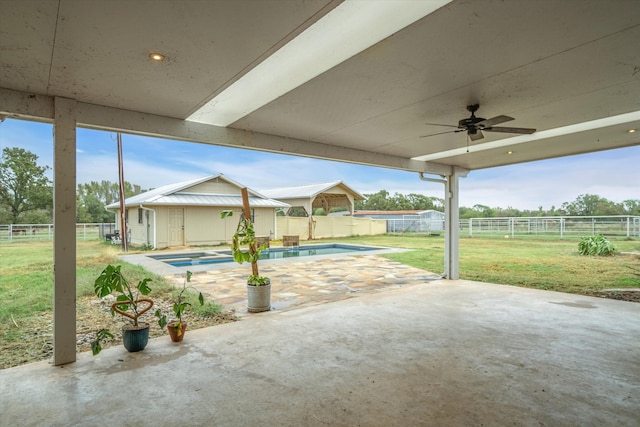 view of patio featuring a fenced in pool and ceiling fan