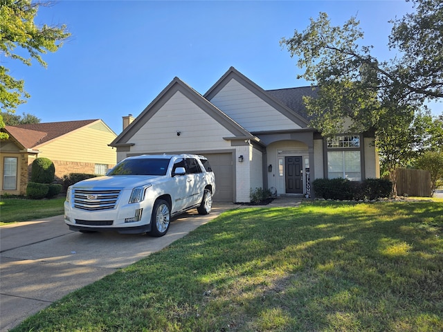 view of front of house with a garage and a front lawn