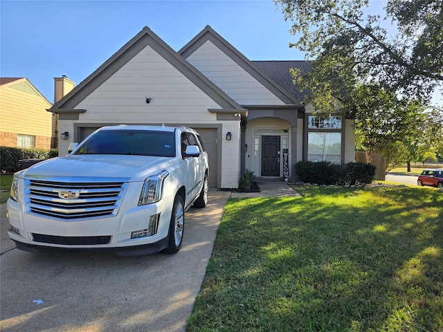 view of front of house with a garage and a front yard