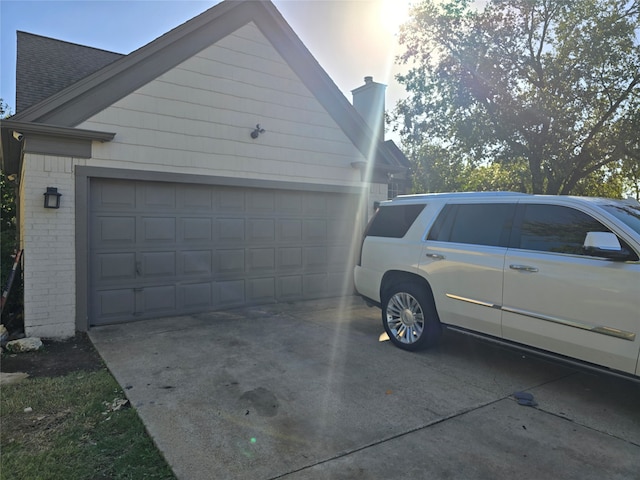 view of side of home featuring a garage