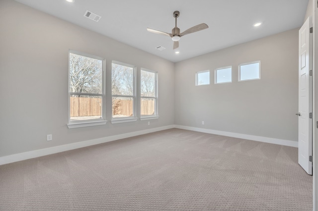 empty room featuring light colored carpet and ceiling fan