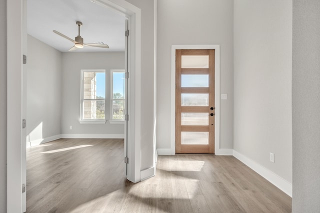 foyer with light hardwood / wood-style floors and ceiling fan