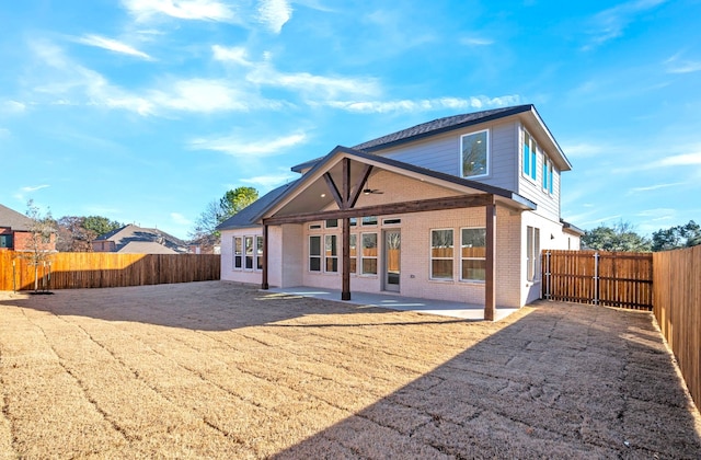 rear view of property featuring a patio area