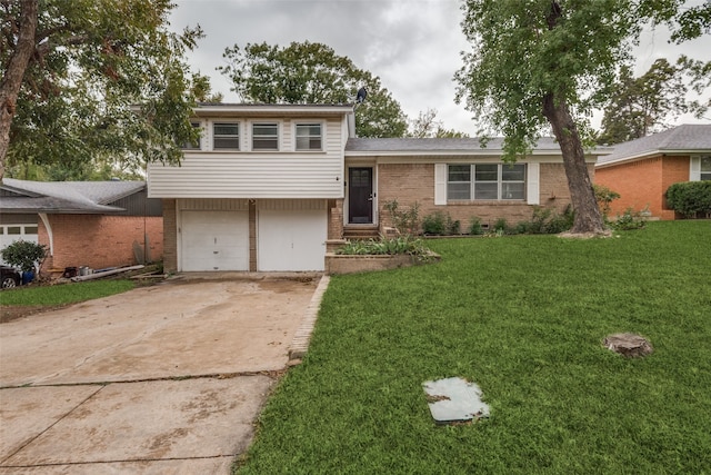 tri-level home with a garage and a front yard