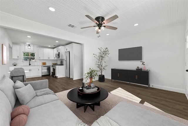 living room with dark hardwood / wood-style flooring and ceiling fan