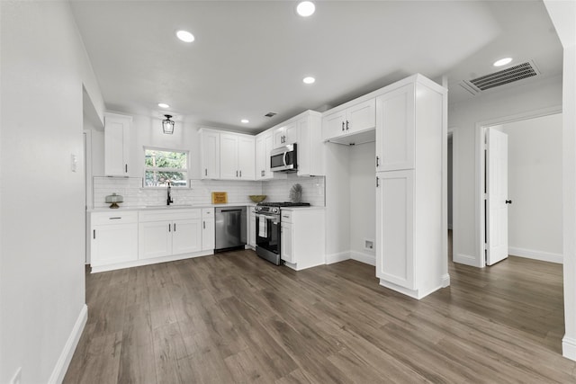 kitchen featuring white cabinetry, appliances with stainless steel finishes, sink, and dark hardwood / wood-style flooring