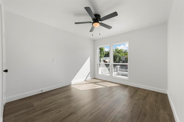 unfurnished room with dark hardwood / wood-style floors and ceiling fan