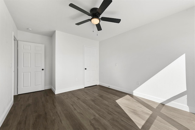 unfurnished bedroom featuring dark hardwood / wood-style flooring and ceiling fan