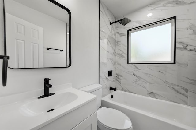 full bathroom with vanity, tiled shower / bath combo, and toilet