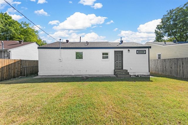 back of property featuring a lawn