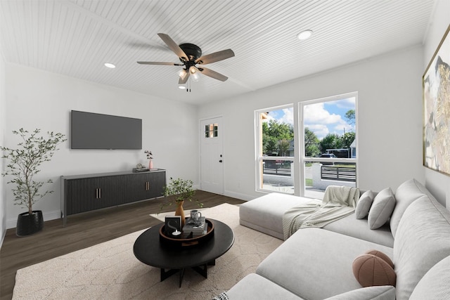 living room featuring dark wood-type flooring and ceiling fan