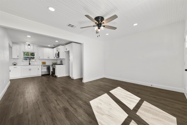 unfurnished living room with dark hardwood / wood-style flooring and ceiling fan