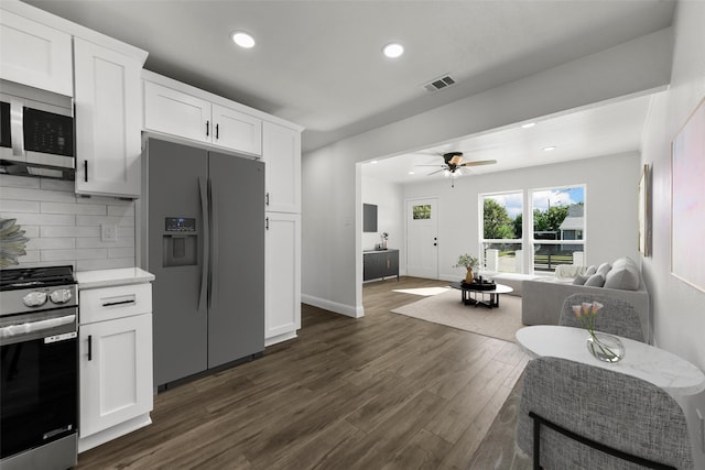 kitchen featuring stainless steel appliances, dark hardwood / wood-style flooring, decorative backsplash, and white cabinets