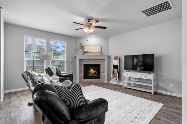 2614 Cowbird Way, Northlake, TX 76247 - living area with a glass covered fireplace, a ceiling fan, and wood finished floors