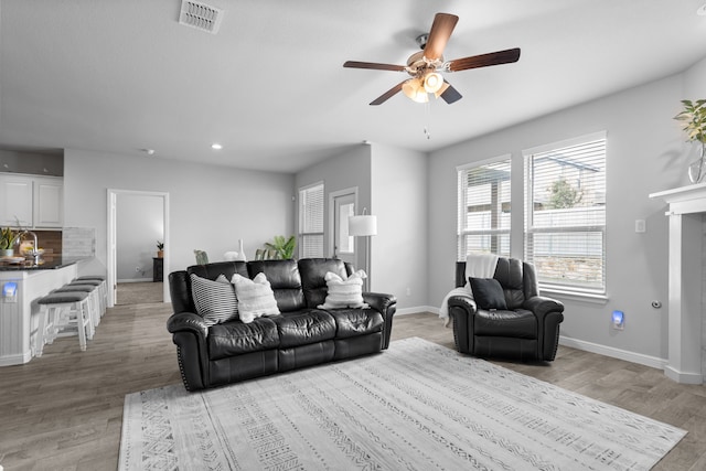 2614 Cowbird Way, Northlake, TX 76247 - living room with ceiling fan, light wood-type flooring, recessed lighting, and a fireplace