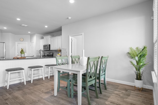 dining room featuring dark hardwood / wood-style floors and sink