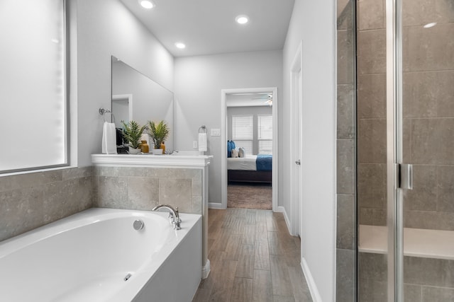 bathroom with independent shower and bath, hardwood / wood-style floors, and ceiling fan