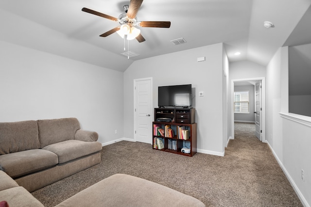 living room featuring carpet, ceiling fan, and vaulted ceiling