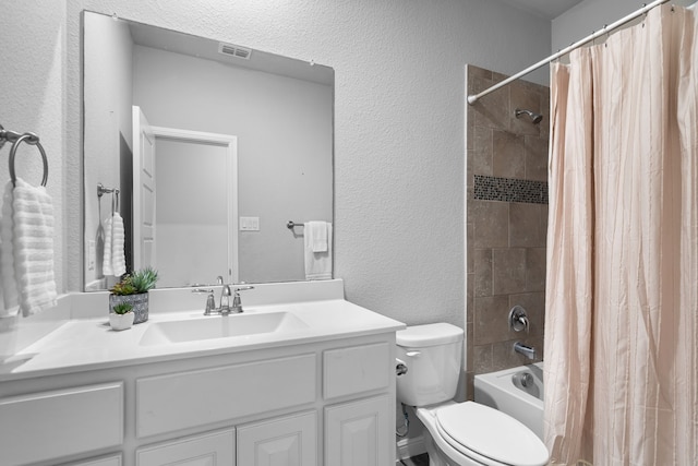 full bathroom featuring vanity, toilet, and shower / bath combination with curtain