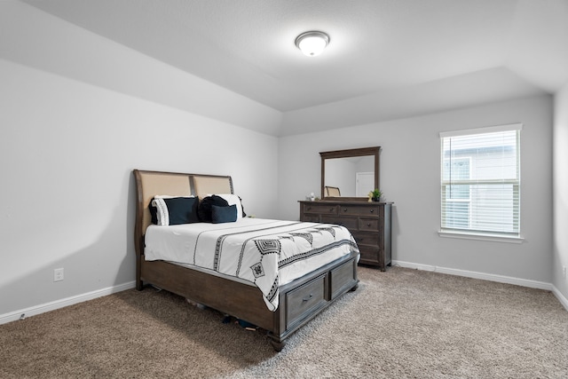 bedroom featuring lofted ceiling and carpet floors