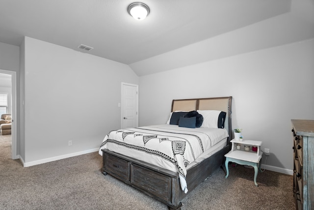 bedroom featuring vaulted ceiling and carpet