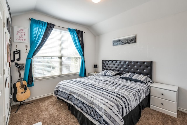 carpeted bedroom with lofted ceiling