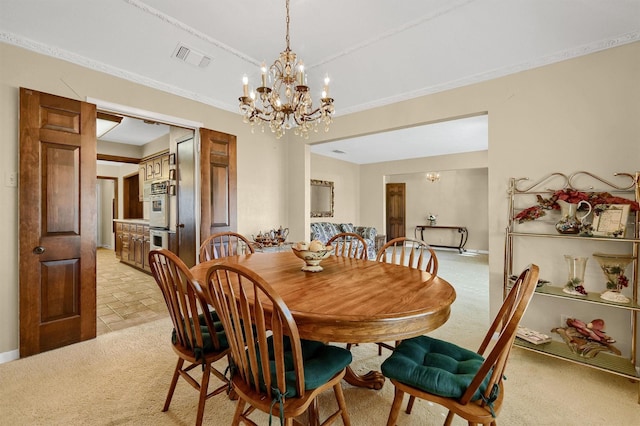 carpeted dining room with an inviting chandelier and ornamental molding