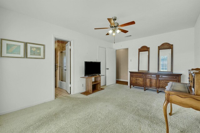 living room featuring light colored carpet and ceiling fan