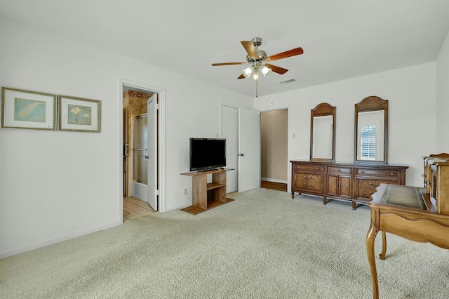 interior space with light colored carpet and ceiling fan