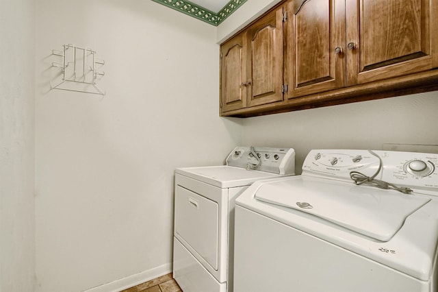 washroom with cabinets and washer and clothes dryer