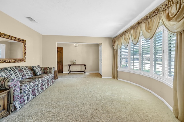 living room with carpet flooring and a notable chandelier