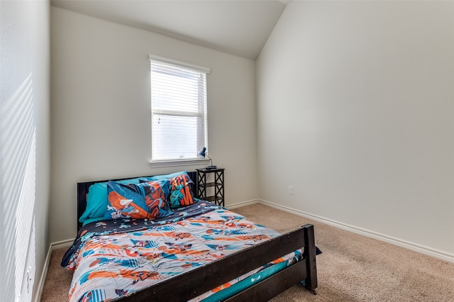 carpeted bedroom featuring vaulted ceiling