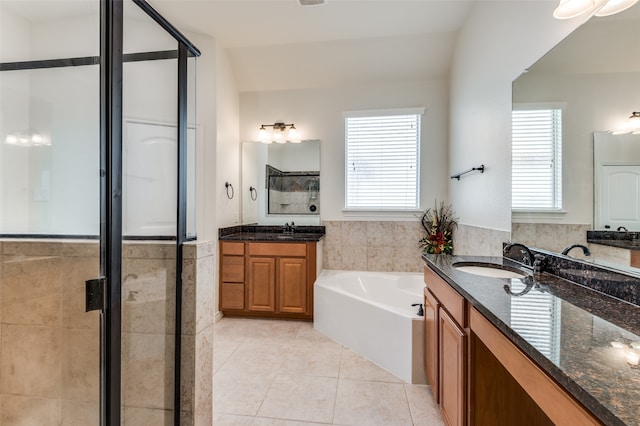 bathroom with tile patterned flooring, a healthy amount of sunlight, separate shower and tub, and tile walls