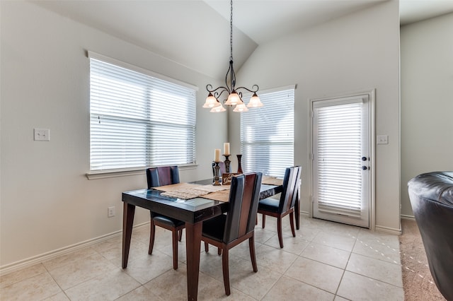 dining area featuring lofted ceiling, light tile patterned floors, and a chandelier