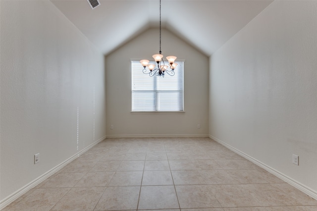 tiled empty room with lofted ceiling and a notable chandelier