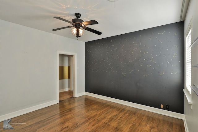 unfurnished room with ceiling fan and dark hardwood / wood-style floors