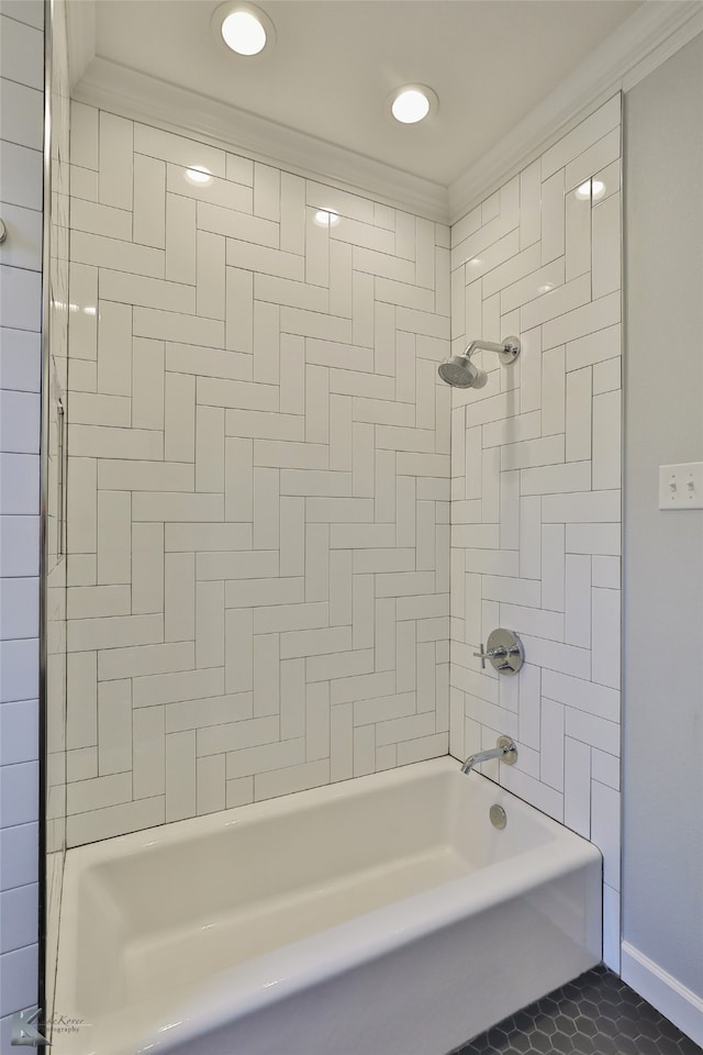 bathroom featuring tiled shower / bath combo, tile patterned flooring, and ornamental molding