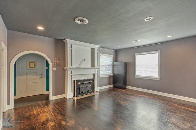 unfurnished living room with dark hardwood / wood-style floors