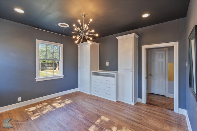 interior space with an inviting chandelier and light hardwood / wood-style flooring