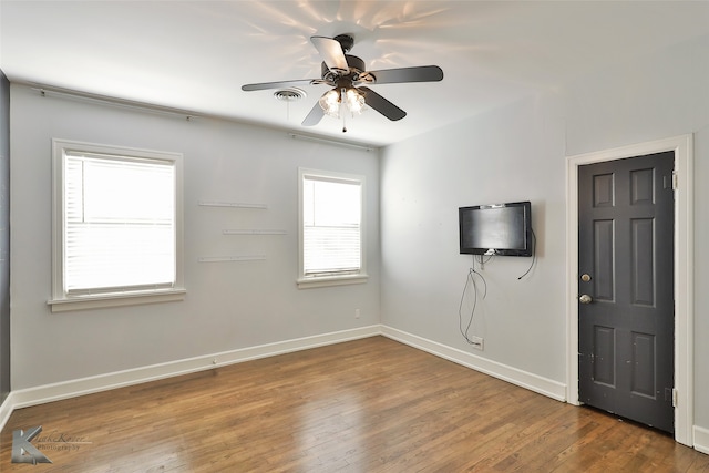 empty room featuring hardwood / wood-style flooring and ceiling fan